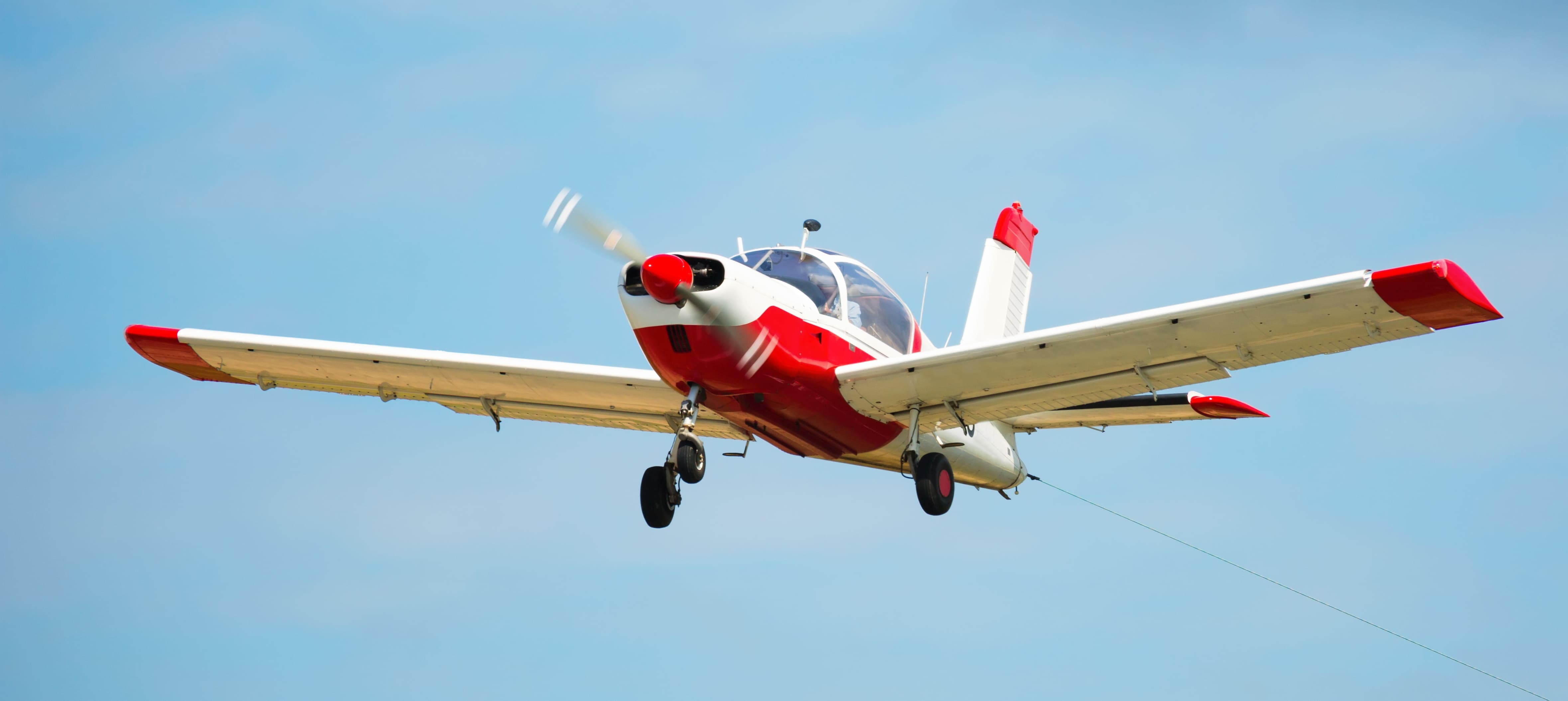 Image of small sports airplane hovering highly in the sky