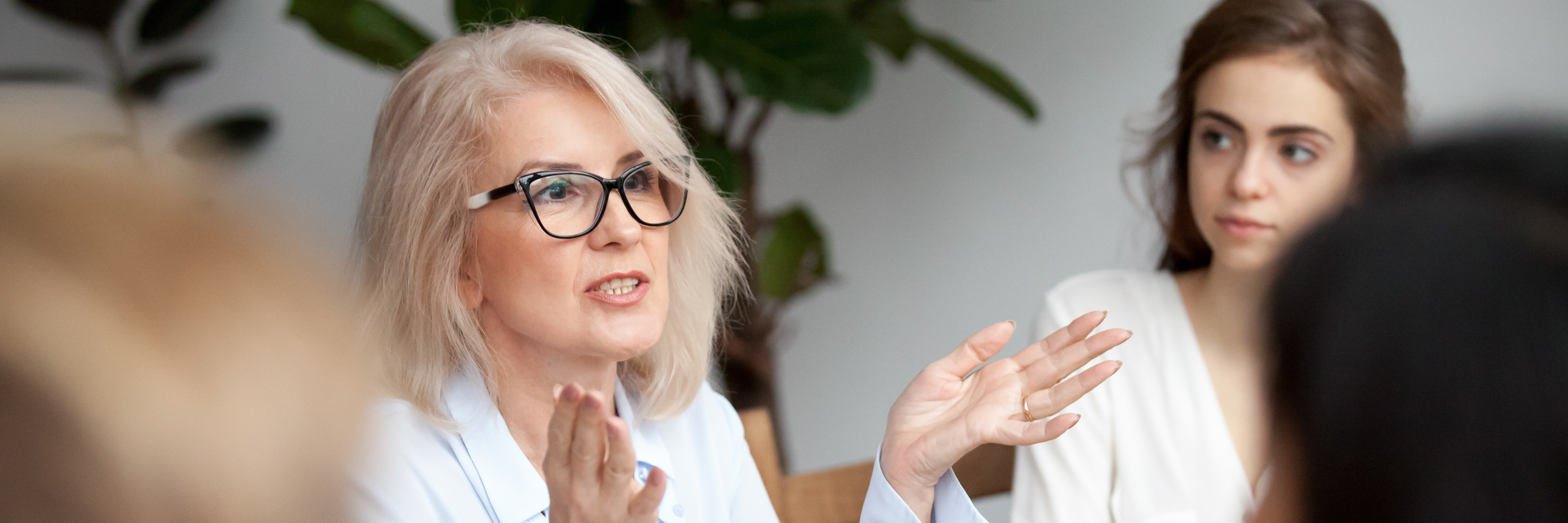 Aged businesswoman coach teach give instructions knowledge to new employees generation people gather at seminar receive new information ideas concept. Horizontal photo banner for website header design