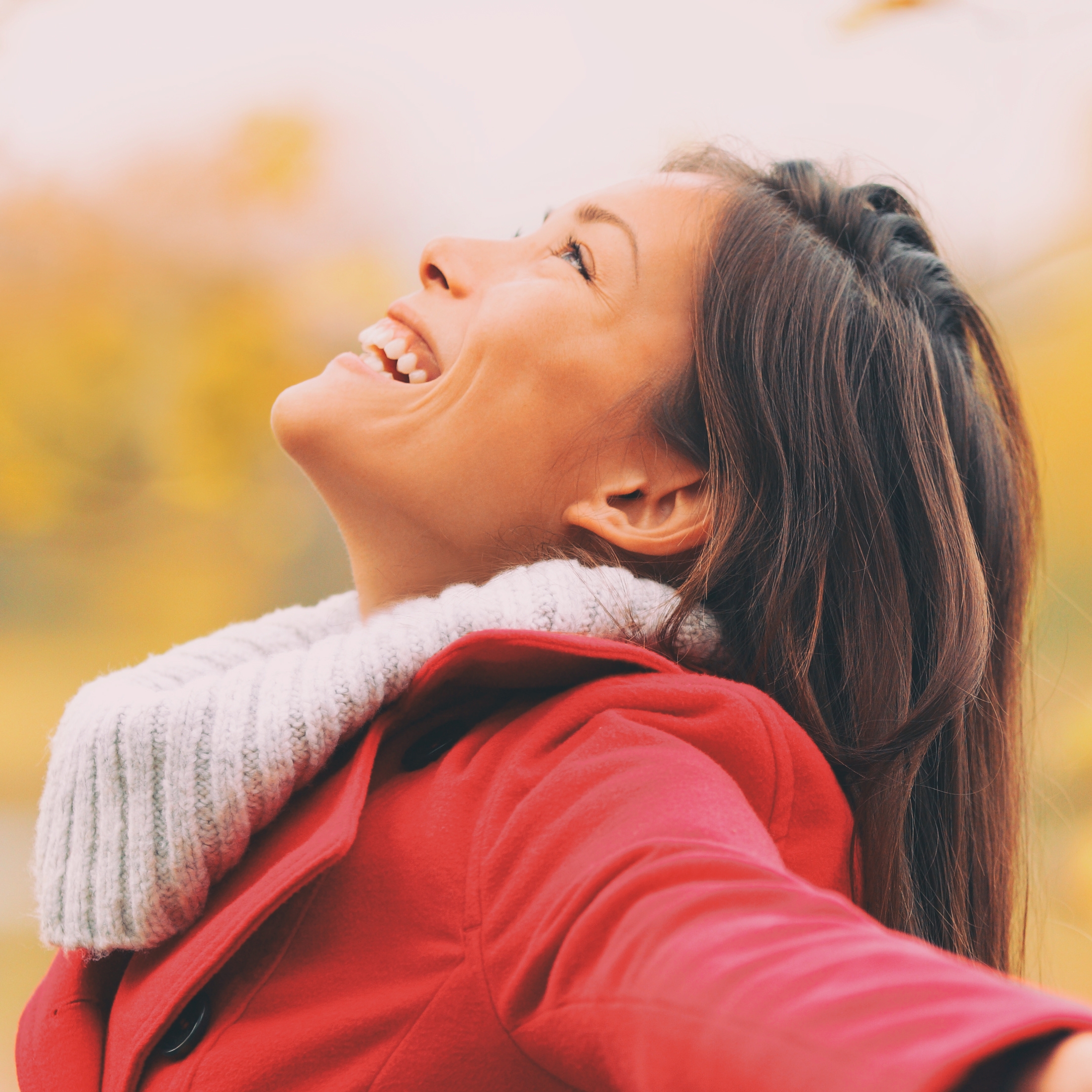 Autumn woman happy smiling feeling free in fall nature. foliage yellow colors of nature. Asian girl by the lake panoramic banner landscape.