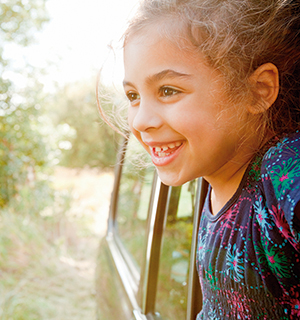 Girl smiling from a car