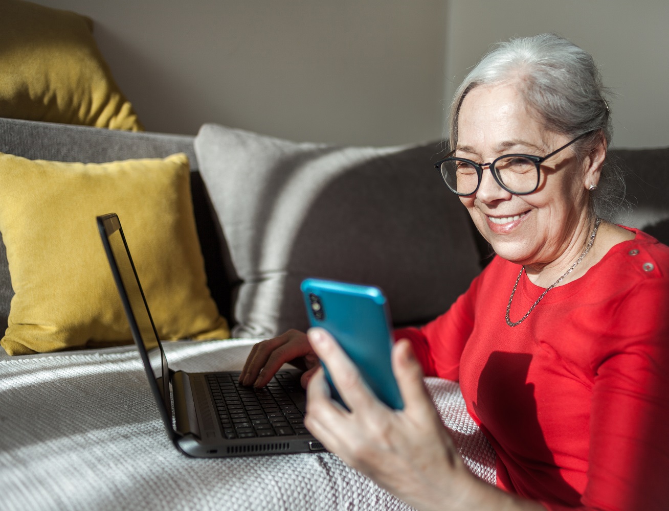 Close up of Senior woman using the phone at home